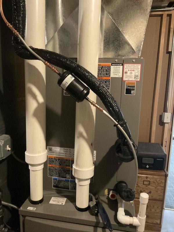 Successfully installed and commissioned new AC system. Completed all installation worksheet requirements and verified proper operation of system. Documented coil serial number and took reference photos of installation components including PVC drainage, copper refrigerant lines, and system connections.