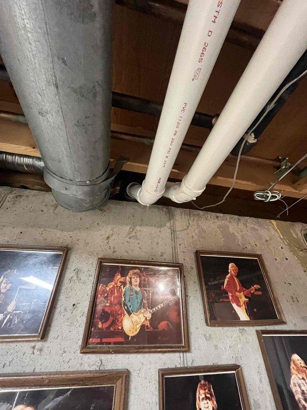 Upgraded existing 2" PVC exhaust venting system to 3" PVC to meet manufacturer specifications and ensure proper condensate drainage and combustion gas venting. Verified system operation and documented installation with photos of control board and completed ductwork installation in basement area.