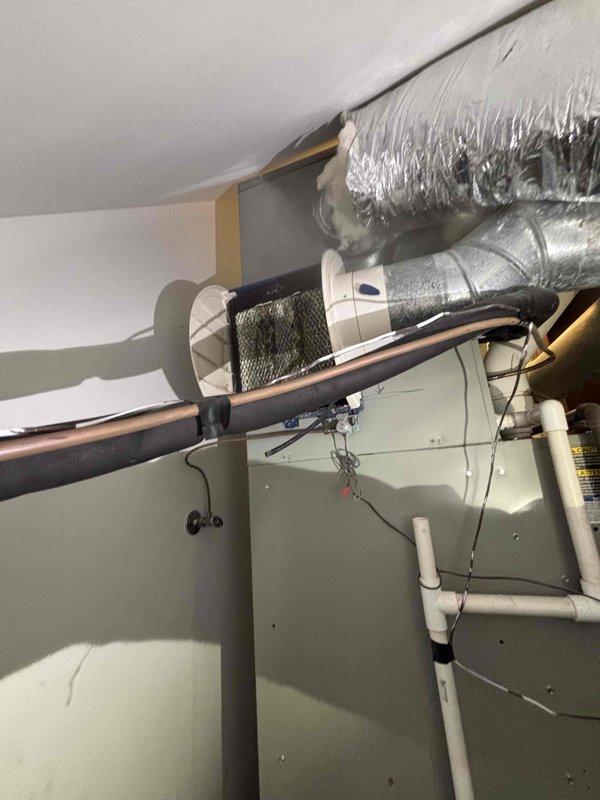 Completed installation of AprilAire 500 bypass humidifier system integrated with existing HVAC air handler in attic mechanical space. Mounted humidifier unit, connected water supply line, installed bypass ductwork between supply and return plenums, and wired humidistat control to furnace board. Verified proper operation, water flow, and damper positioning for optimal indoor air quality performance.