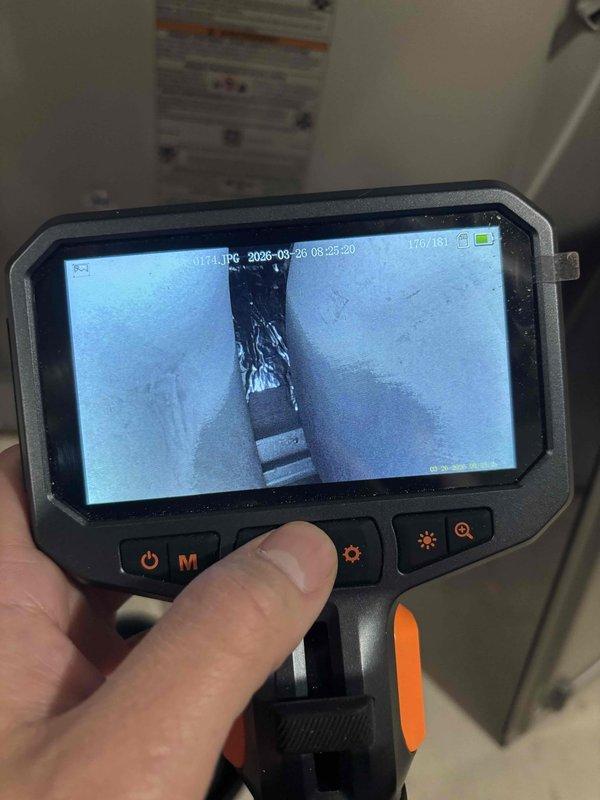 Performed comprehensive heat exchanger inspection on 8+ year old HVAC unit using borescope camera equipment. Conducted thorough visual examination of internal heat exchanger surfaces and evaporator coil fins to assess condition and identify any signs of deterioration, cracking, or potential safety concerns. All components were accessible and inspected without complications, with detailed photographic documentation captured for service records.