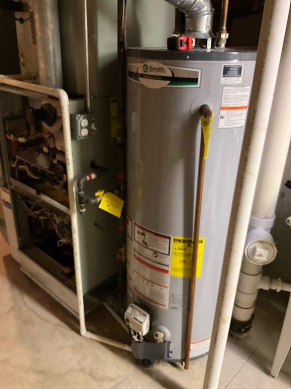 Conducted comprehensive assessment of 15-year-old residential HVAC system including furnace and air conditioning unit to evaluate condition and provide full system replacement estimate. Documented existing equipment configuration in basement mechanical room, including furnace with protective cardboard wrapping, A.O. Smith water heater, ACM humidifier unit, and associated ductwork and PVC piping. Photographed current system layout showing metallic ductwork connections, access panels, and mechanical components to support replacement proposal. Discussed system replacement options with homeowner and presented available promotional incentives and combination discounts for complete HVAC system installation.