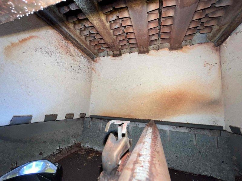 Responded to service call for boiler system with uneven heating throughout the home that had persisted for approximately two weeks. Upon inspection, discovered severely corroded heat exchanger with extensive rust formation on metal fins and internal components, indicating advanced deterioration and potential safety concerns. Documented equipment condition showing significant oxidation on copper piping, heat exchanger degradation, and debris accumulation within the unit, requiring immediate attention to restore proper heating distribution and system safety.