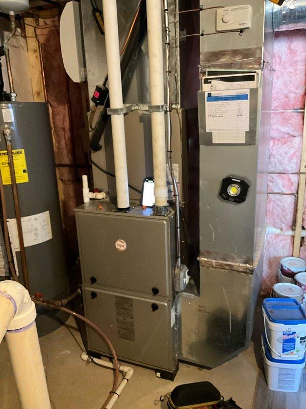 Responded to service call for furnace malfunction initially suspected to be thermostat-related. Customer had contacted Ecobee support who indicated potential high limit switch issue with the heating system. Upon arrival, performed diagnostic inspection of furnace unit located in basement mechanical room. Conducted electrical testing using clamp meter to verify current draw and system operation. Inspected high limit switch, safety controls, and associated wiring. Examined furnace operation through complete heating cycle to assess component functionality. Documented equipment condition and diagnostic findings with photographs of furnace installation and electrical measurements for service records.