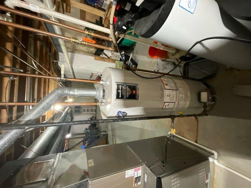 Responded to service call for reported water heater leak at residential property. Upon inspection of basement utility area, assessed tanked water heater unit and surrounding plumbing connections. Examined all visible pipe connections, pressure relief valve, drain valve, and tank integrity for signs of active leaking or moisture accumulation. Inspected copper supply lines, flexible hose connections, and shutoff valves for corrosion or deterioration. Verified proper venting configuration and clearances around unit. Documented equipment condition and plumbing infrastructure with photographic evidence for service records.