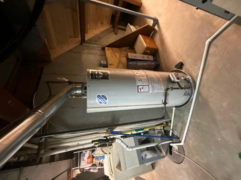 Completed comprehensive plumbing inspection as part of Building Facilities Maintenance Agreement tune-up service. Performed thorough evaluation of bathroom fixtures including toilet installation, supply lines, shut-off valves, and floor mounting integrity. Inspected water heater system in utility area, examining copper piping connections, pressure relief valve operation, and overall unit condition. All plumbing components found to be functioning properly with no leaks or immediate concerns identified.