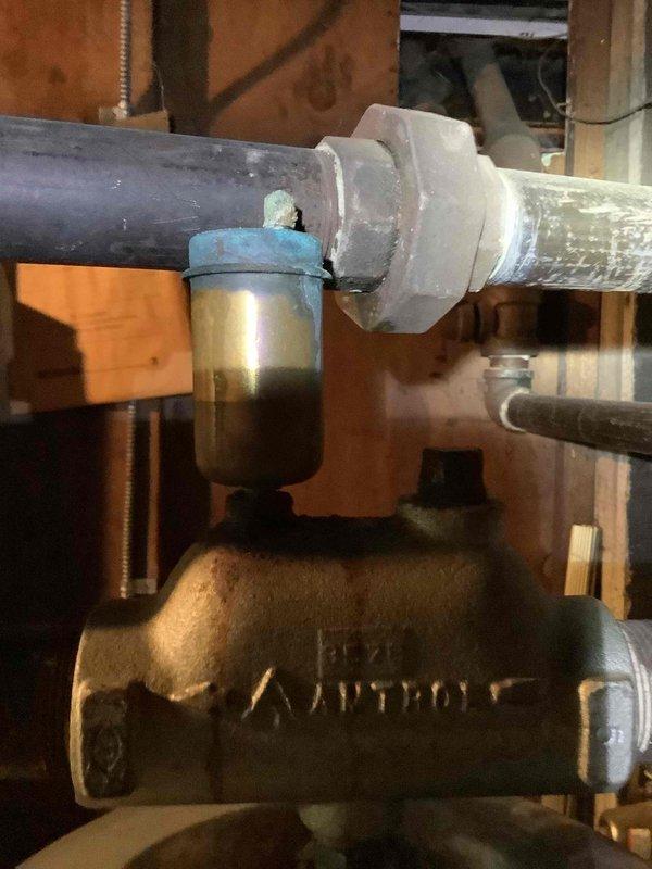 Conducted comprehensive site assessment for boiler replacement estimate at residential property. Evaluated existing hydronic heating system components including zone valves, circulation pumps, and associated piping infrastructure located in attic space. Documented current system conditions showing aged flexible ductwork connections, deteriorated insulation backing on surrounding framing, and existing brass valve assemblies with filtration components. Assessed accessible plumbing connections, PVC venting configuration, and mechanical equipment placement for replacement specifications. Photographed installation area to determine proper equipment sizing, clearance requirements, and integration points for new boiler system.