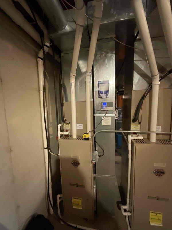 Conducted comprehensive site evaluation for full HVAC system replacement serving first floor. Documented existing dual-furnace configuration in mechanical room, including current electrical distribution panel with dedicated circuits for Furnace 1, Furnace 2, AC unit, water heater, and associated outlets. Assessed existing ductwork infrastructure, PVC venting system, and equipment placement to develop accurate replacement proposal for aging HVAC equipment.