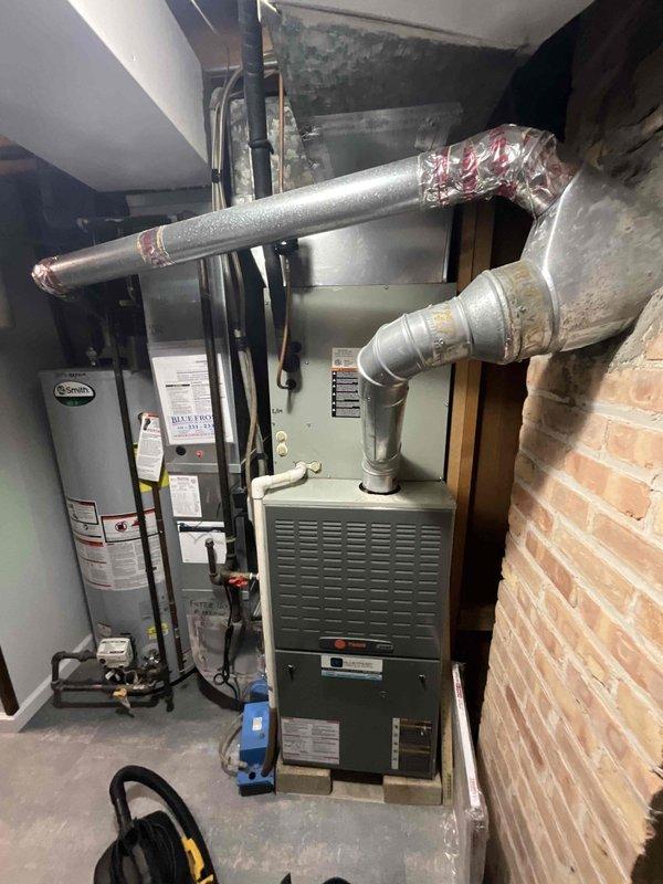 Completed comprehensive furnace tune-up on 16+ year old residential heating system located in basement mechanical room. Performed full preventative maintenance inspection including cleaning and testing of all major components, verified proper operation of burners and heat exchanger, checked gas connections and pressures, inspected and cleaned blower assembly, tested safety controls and limit switches, examined venting system and flue pipe connections to brick chimney, and confirmed adequate airflow through ductwork system. All components found to be functioning within acceptable parameters at time of service. Provided client with quote information for future furnace and air conditioning replacement system as requested.