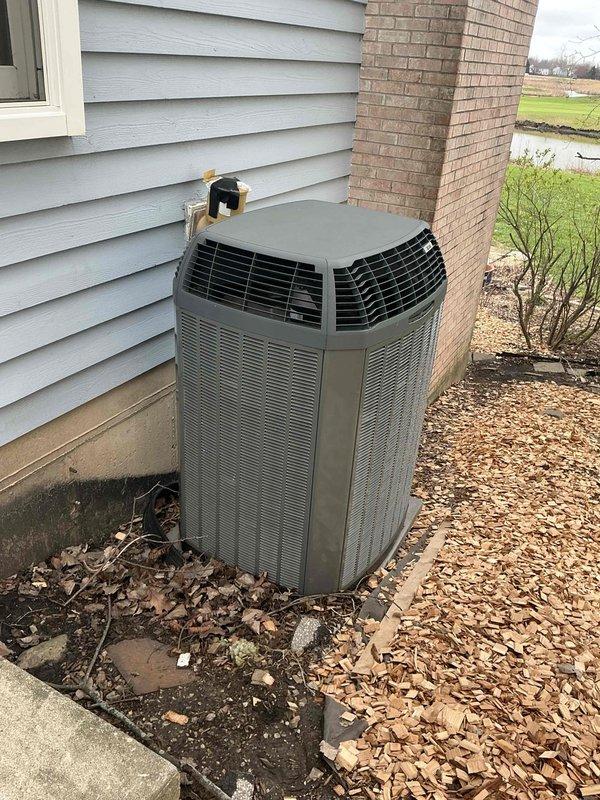 Conducted HVAC assessment for residential air conditioning system replacement. Customer expressed interest in replacement options for existing 15-year-old system. Evaluated indoor furnace unit located in basement mechanical room showing age-related wear, and inspected outdoor condenser unit positioned against exterior wall near chimney. Documented current equipment condition and configuration including ductwork connections and electrical service. Prepared comprehensive replacement estimate presenting multiple air conditioning and coil upgrade options to improve system efficiency and reliability.