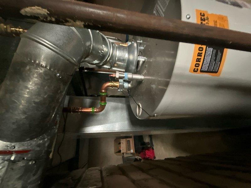 Installed 40-gallon domestic water heater in residential basement mechanical room. Removed existing well anode rod and replaced with electric anode rod to address water odor issue as recommended by water quality specialist. Installation included proper connections to copper supply lines with shutoff valves, venting ductwork, and electrical components. All components tested and verified operational upon completion.