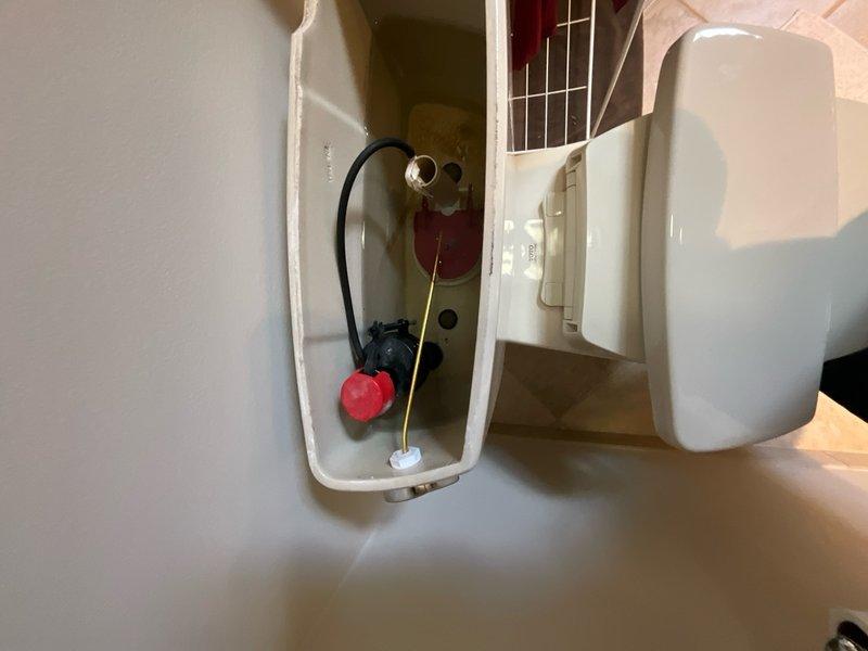 Performed comprehensive plumbing inspection of the property and addressed a reported issue with the master bathroom toilet. Inspected the toilet tank's internal components, including the fill valve assembly, flush valve mechanism, float ball system, and overflow tube to diagnose the malfunction and ensure proper operation.