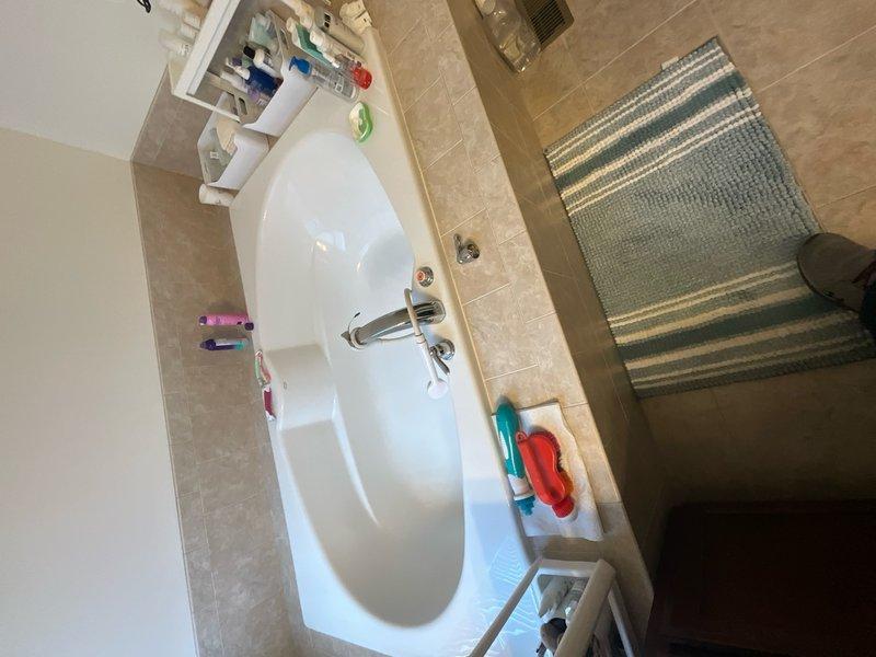 Repaired dripping shower faucet in residential bathroom by replacing worn cartridge and seals on 15-year-old chrome fixture. Tested water flow and temperature control to ensure proper operation with no leaks detected upon completion.