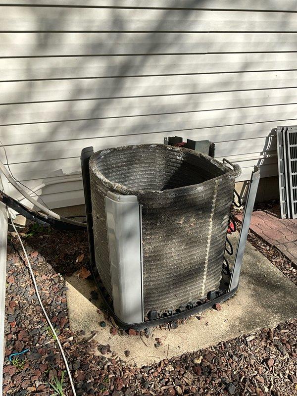 Completed comprehensive BFMA tune-up on 20+ year old outdoor air conditioning unit. Upon arrival, found condenser coils heavily clogged with dirt, dust, and debris accumulation significantly restricting airflow. Performed thorough cleaning of condenser coils and exterior surfaces to restore proper heat transfer efficiency. Inspected electrical components including capacitor, wiring connections, and control circuits. Verified all electrical connections were secure and tested capacitor functionality. Cleared vegetation and debris from unit perimeter and base. Unit operational and running within normal parameters upon completion.