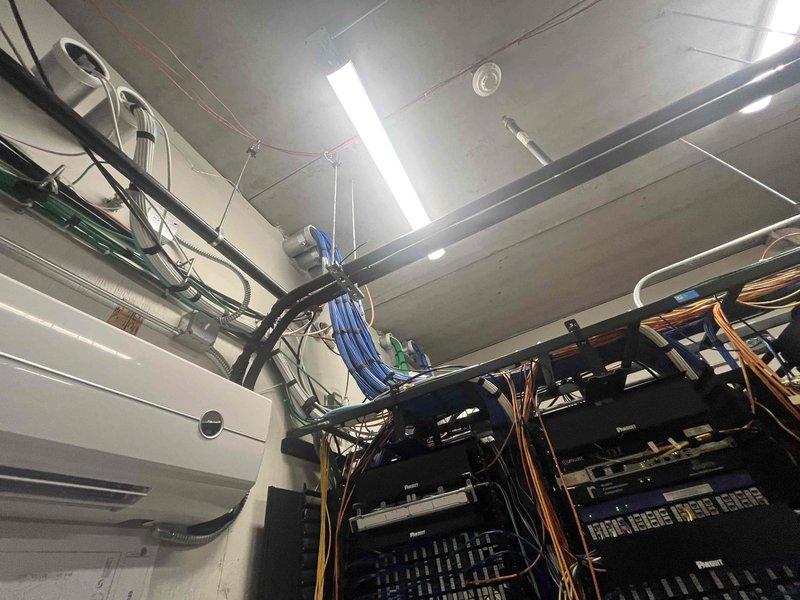 Conducted on-site assessment for commercial mini split installation at two locations. Evaluated existing outdoor HVAC area with current condensing unit and infrastructure, as well as interior ceiling space containing extensive electrical conduit, cable management systems, and network equipment to determine optimal placement and routing for new mini split systems.