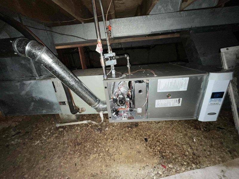 Completed comprehensive BFMA tune-up on 26-year-old residential HVAC system located in attic space. Discovered heavily soiled air filter with significant accumulation of dust, debris, and wood particulate matter restricting airflow; replaced filter to restore proper system ventilation and efficiency. Performed standard maintenance inspection of horizontal air handler unit, checked blower motor assembly, verified electrical connections, inspected ductwork and refrigerant lines, and confirmed all mechanical components operating within normal parameters.