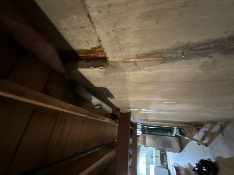 Conducted on-site assessment for ductwork removal required to facilitate wall repair due to active water leak. Evaluated existing HVAC system configuration in confined ceiling cavity, including horizontal metal supply duct with insulated branch runs secured to structural framing. Documented water-damaged ceiling areas showing brown staining and deterioration near ductwork penetrations. Provided estimate for temporary ductwork disconnection and removal to allow access for plumbing repairs and structural wall support, with subsequent reinstallation upon completion of remediation work.