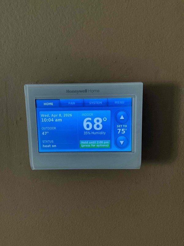 Completed comprehensive tune-up maintenance on both furnace and air conditioning systems at property with equipment ages of 2 and 10 years. Performed standard preventive maintenance procedures including inspection of all major components, capacitor testing and dating, control board verification, and thermostat functionality check. All systems operational with thermostat holding temperature setpoint as programmed; indoor conditions reading 68°F at 35% humidity with outdoor temperature at 47°F.