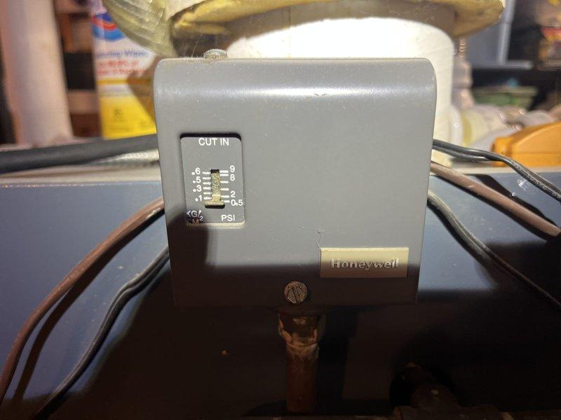 Completed comprehensive BFMA tune-up service on dual heating system consisting of 6-year-old heat pump and 27-year-old boiler. Inspected and tested Honeywell pressure control switch on boiler system, verifying proper cut-in pressure settings and electrical connections. Performed preventive maintenance on heat pump evaporator coils, noting standing water in drain pan and some fin discoloration indicating normal operational wear. Verified all safety controls, tested system operations, and confirmed both heating units functioning within manufacturer specifications.