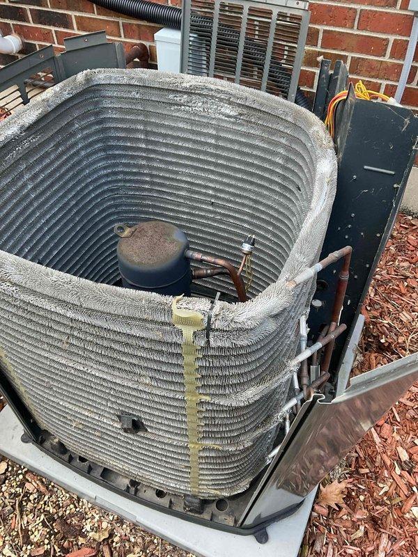 Completed scheduled BFMA tune-up maintenance on two residential air conditioning units. The first outdoor condenser unit exhibited severe accumulation of dust, dirt, and debris on the condenser coils, with thick matted buildup significantly restricting airflow and reducing system efficiency. Removed top protective grille to access interior components, thoroughly cleaned condenser coils to restore proper heat transfer capability, and inspected compressor, capacitor, and refrigerant lines. The second unit was found in good operating condition with minimal debris accumulation. Performed standard maintenance procedures on both systems including inspection of electrical connections, disconnect boxes, and all accessible components to ensure safe and efficient operation for the cooling season.