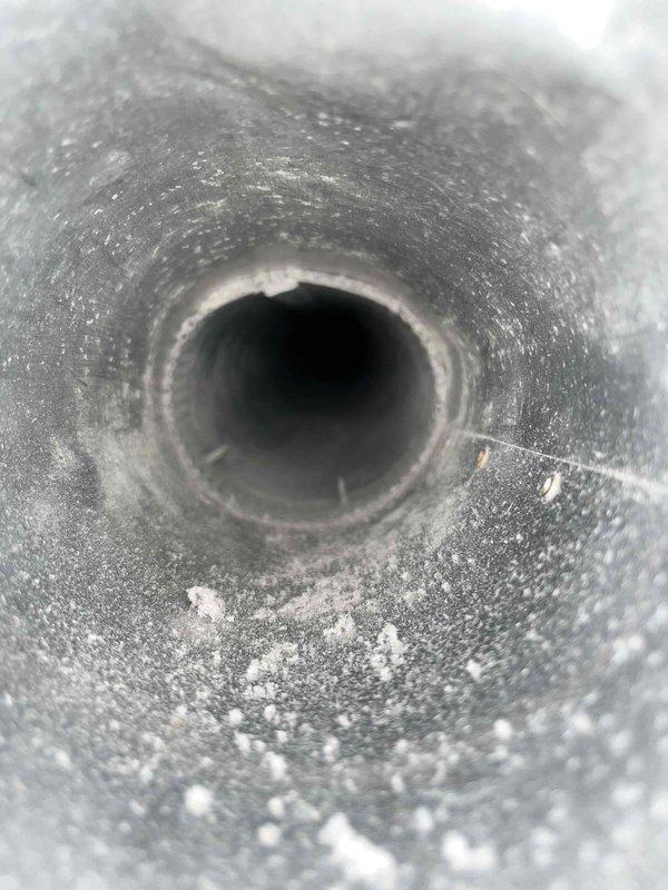 Completed dryer vent cleaning service during late morning appointment. Upon inspection, the vent duct interior showed significant accumulation of lint, dust, and debris coating the metallic walls, which posed a potential fire hazard and reduced airflow efficiency. Thoroughly cleaned the entire dryer vent system using professional rotary brush equipment, removing all built-up particulate matter from the ductwork to restore proper ventilation and ensure safe operation of the dryer appliance.