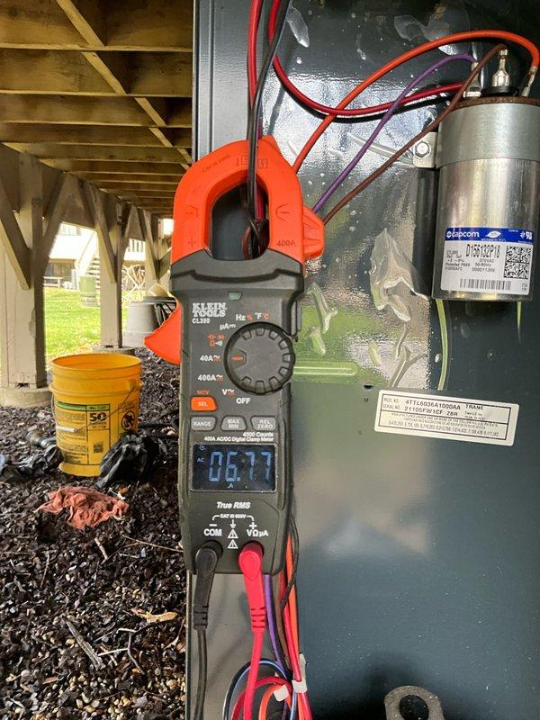 Performed comprehensive air conditioning tune-up on 4-year-old residential outdoor condensing unit. Conducted electrical diagnostics using clamp meter, measuring amperage draw at 6.1 amps and verifying proper voltage to compressor and capacitor. Inspected condenser coils, which showed normal wear and minor debris accumulation from outdoor exposure beneath deck structure. Verified all electrical connections, tested capacitor performance, and confirmed unit operational parameters within manufacturer specifications.