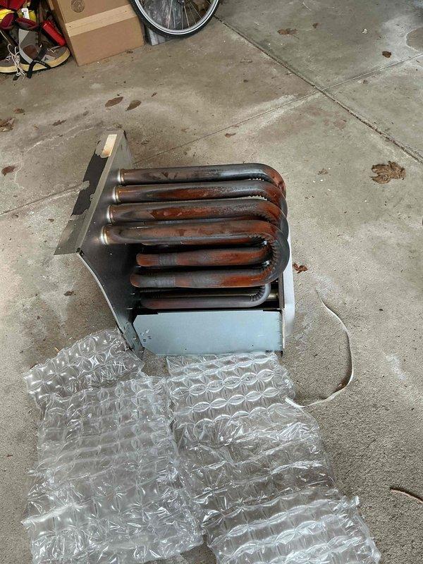 Replaced heavily corroded heat exchanger unit due to extensive oxidation and rust buildup on the serpentine coil assembly. The old component was removed, staged at headquarters for proper disposal, and documented with photographic evidence showing the deteriorated condition of the metallic tubing and housing.