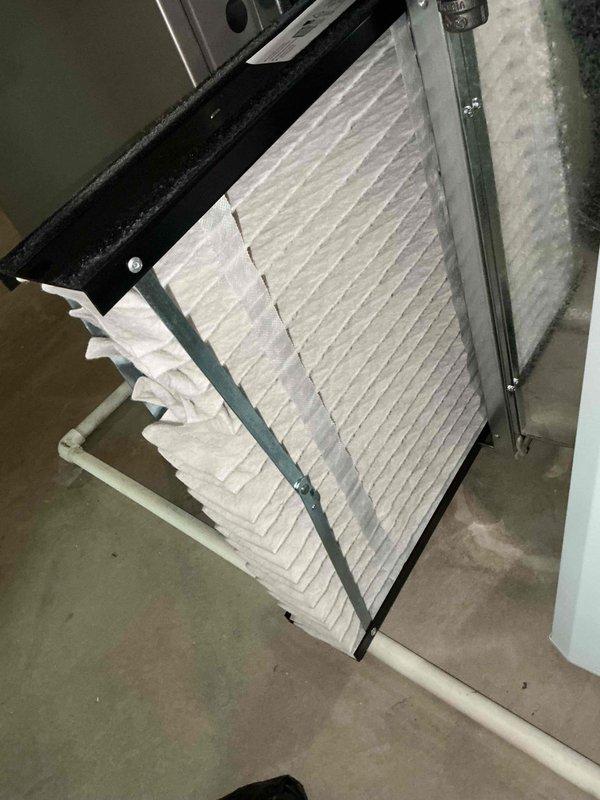 Completed comprehensive BFMA tune-up on 12-year-old residential air conditioning system. Performed full system inspection including indoor air handler with filter evaluation and outdoor condenser unit assessment. Connected manifold gauge set to condenser unit to verify refrigerant pressures and system performance parameters. Inspected pleated air filtration system in air handler, confirmed proper installation and airflow capacity. Evaluated outdoor condenser unit operation, checked electrical connections, and assessed overall system functionality. All components found operating within normal specifications, system running efficiently with no immediate service concerns identified.
