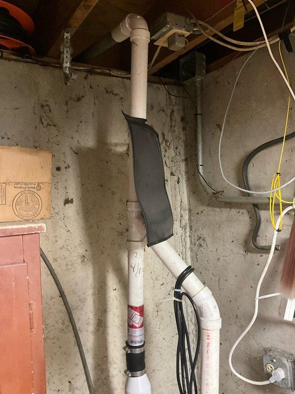 Responded to a sump pump failure in a basement utility area. Replaced the failed sump pump system, including new discharge piping and electrical connections. Verified proper operation of the new pump, tested float switch functionality, and ensured adequate drainage through the existing PVC discharge lines that run vertically along the foundation wall to the exterior discharge point.
