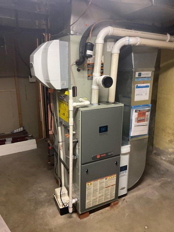 Completed comprehensive BFMA tune-up on residential HVAC system including air conditioning performance evaluation and filter replacement. Inspected heat exchanger fins, verified refrigerant lines, condensate pump operation, and all system connections including PVC drainage and ductwork. Addressed thermostat alert notifications, confirmed all equipment operating within normal parameters, and cleared non-critical system alerts after verifying proper function of 4+ year old dual-unit installation with humidifier integration.