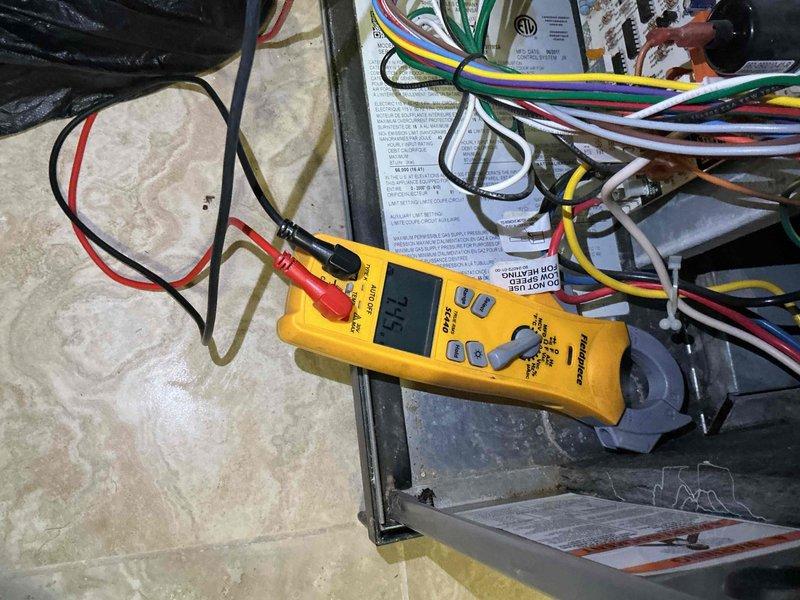 Completed comprehensive air conditioning tune-up maintenance service for residential system. Performed electrical diagnostics using digital multimeter to test voltage and amperage at system components in attic space, verifying proper electrical connections and circuit integrity across all wiring. Inspected water heater installation in utility closet, noting circulation pump operation and plumbing connections as part of overall system assessment to ensure home readiness.