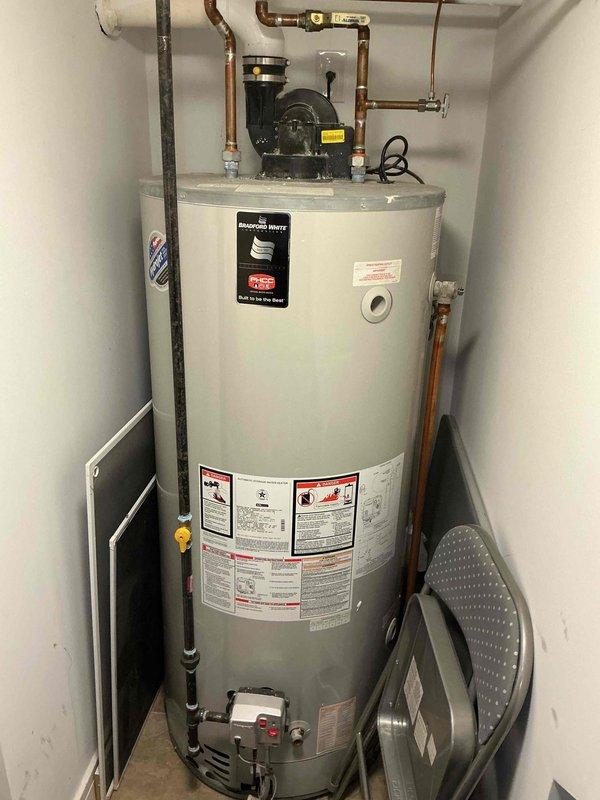 Completed comprehensive air conditioning tune-up maintenance service for residential system. Performed electrical diagnostics using digital multimeter to test voltage and amperage at system components in attic space, verifying proper electrical connections and circuit integrity across all wiring. Inspected water heater installation in utility closet, noting circulation pump operation and plumbing connections as part of overall system assessment to ensure home readiness.