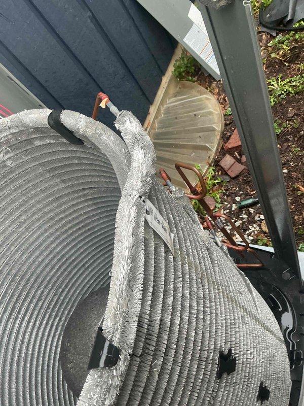 Completed comprehensive BFMA tune-up service on a one-year-old outdoor AC condenser unit. Performed full system inspection including examination of refrigerant lines, electrical connections, compressor components, and condenser coil condition. All copper refrigerant lines, electrical wiring, relays, and mechanical components were inspected and found to be operating within normal parameters with typical oxidation present on copper tubing consistent with equipment age.