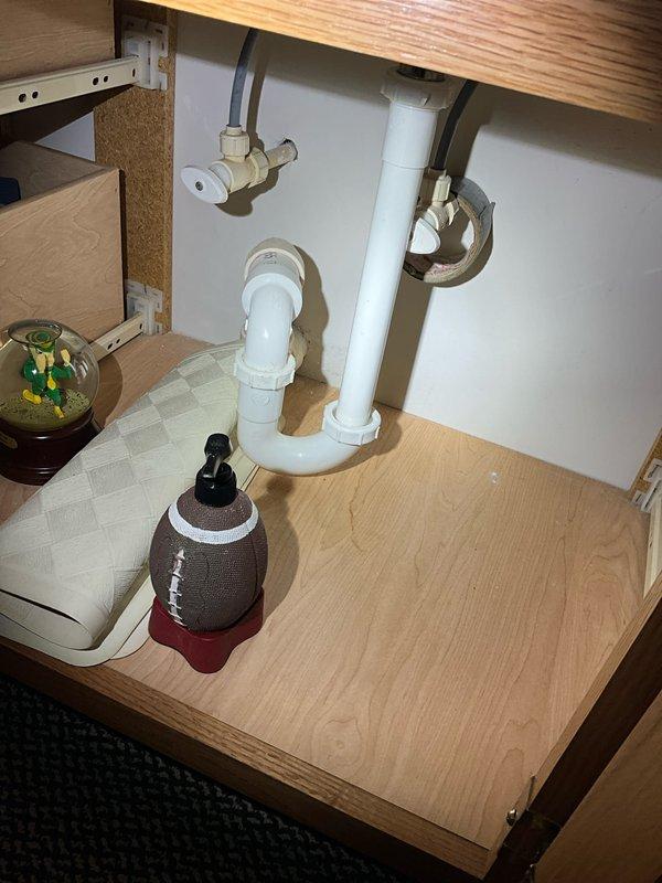 Completed comprehensive plumbing inspection of residential property, examining water heater installation in utility room and under-sink plumbing configuration in kitchen. All components, including Richmond water heater, supply lines, shut-off valves, P-trap assembly, and drainage system were inspected and found to be in proper working order with no leaks or deficiencies identified.