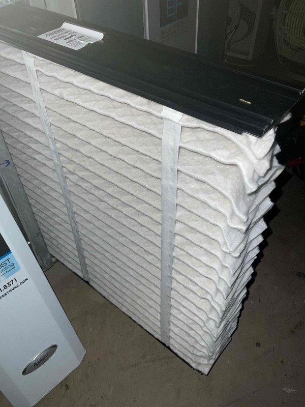 Completed comprehensive air conditioning and furnace tune-up at residential property. Performed full system inspection of HVAC equipment located in basement mechanical room, including dark-colored furnace unit with metallic exhaust duct system. Verified proper operation of all components, checked electrical connections at breaker panel, and inspected humidifier integration. Confirmed adequate supply of replacement air filters on-site and documented equipment condition through photographic records. All systems operating within normal parameters upon completion of preventive maintenance service.