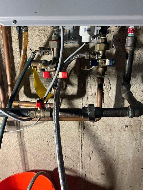 Performed comprehensive tankless water heater flush and tune-up on unit aged 10-12+ years. Isolated unit using service valves, connected flushing pump and hoses to inlet and outlet ports, and circulated descaling solution through heat exchanger to remove mineral buildup and scale deposits. Verified proper drainage, reconnected all plumbing connections, and restored unit to normal operation with improved efficiency.