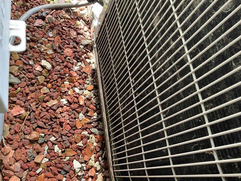 Completed comprehensive BFMA tune-up on 8+ year old outdoor AC unit. Upon arrival, contacted homeowner to secure pet before beginning service. Performed complete system inspection including electrical testing of capacitors and connections using digital multimeter. Unit exterior showed normal weathering with accumulated dirt and debris on protective grille and coil fins. Verified all electrical components functioning within specifications, tested capacitor values, and inspected condenser coil condition. System operating properly with no immediate concerns identified.