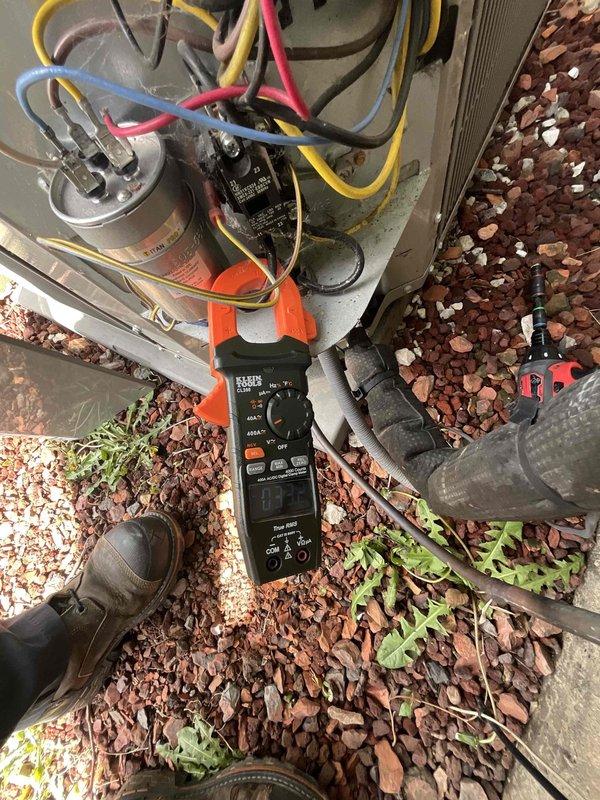 Completed comprehensive BFMA tune-up on 8+ year old outdoor AC unit. Upon arrival, contacted homeowner to secure pet before beginning service. Performed complete system inspection including electrical testing of capacitors and connections using digital multimeter. Unit exterior showed normal weathering with accumulated dirt and debris on protective grille and coil fins. Verified all electrical components functioning within specifications, tested capacitor values, and inspected condenser coil condition. System operating properly with no immediate concerns identified.