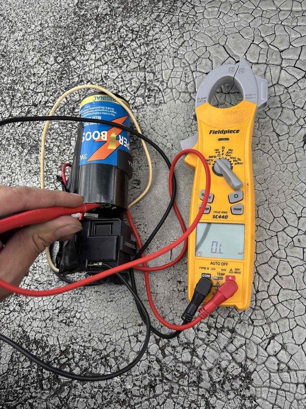 Responded to no-cooling call and found tripped circuit breaker at electrical panel. Upon investigation, diagnosed failed run capacitor as root cause of overcurrent condition. Tested capacitor with clamp meter, confirming zero microfarad reading and complete failure. Replaced defective capacitor with proper OEM replacement, reset circuit breaker, and verified system operation with normal amp draw and proper cooling cycle.