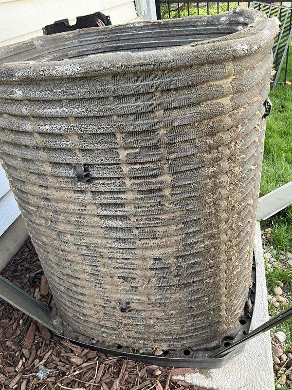 Completed comprehensive AC tune-up on 6+ year old system, coordinating arrival time with homeowner's work schedule for afternoon service. Performed thorough cleaning of heavily clogged outdoor condenser unit, which had extensive debris accumulation completely obscuring coil fins and significantly restricting airflow; removed layers of dirt, dust, and environmental buildup from all coil surfaces to restore proper heat transfer efficiency. Verified Trane thermostat operation showing system in cooling mode set to 72°F with indoor humidity at 48%, confirmed proper communication between thermostat and equipment, and ensured all system components functioning correctly following maintenance procedures.