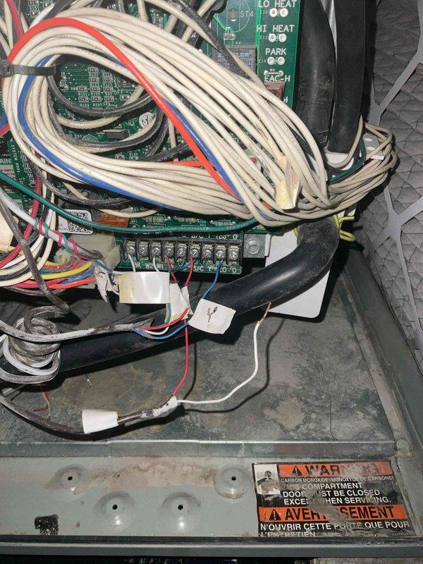 Responded to no heat call at 24/7 commercial facility where one bedroom was not heating properly. Upon arrival, accessed HVAC unit and inspected control panel and electrical components. Examined circuit boards, wiring connections, and control sequences including low heat, high heat, cooling, and economizer functions. Verified all wire terminations at control board were secure and inspected multicolored wire bundles for proper connections. Documented system configuration and control panel layout with photographs for service records. All electrical connections appeared intact with no visible signs of damage or loose terminations at wire connectors.