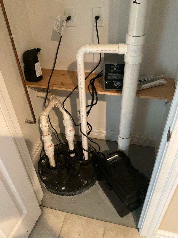 Completed comprehensive plumbing inspection of residential property during morning service call. Inspected and documented sump pump system with PVC discharge piping, electrical connections, and control unit in utility area, confirming proper installation and operation. Examined bathroom plumbing fixtures including toilet, bidet sprayer assembly, and associated hardware, verifying all components are functioning correctly with no visible leaks or deficiencies noted.
