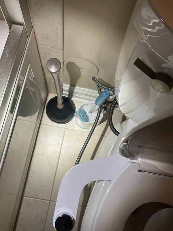 Completed comprehensive plumbing inspection of residential property during morning service call. Inspected and documented sump pump system with PVC discharge piping, electrical connections, and control unit in utility area, confirming proper installation and operation. Examined bathroom plumbing fixtures including toilet, bidet sprayer assembly, and associated hardware, verifying all components are functioning correctly with no visible leaks or deficiencies noted.