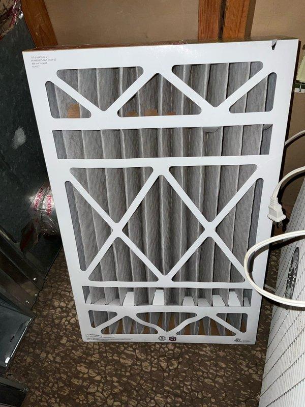 Completed comprehensive BFMA tune-up on 16+ year old air conditioning system. Removed access panel and discovered significant accumulation of grass clippings, plant material, and debris throughout electrical compartment surrounding contactor, capacitor, circuit board, and wiring connections. Cleaned all internal components, removed organic debris from electrical compartment to prevent potential fire hazard and ensure proper airflow. Inspected and tested contactor, capacitor, and all electrical connections for proper operation. Replaced dirty air filter with visible dust accumulation. Verified system operation and confirmed unit is functioning properly following debris removal and component inspection.