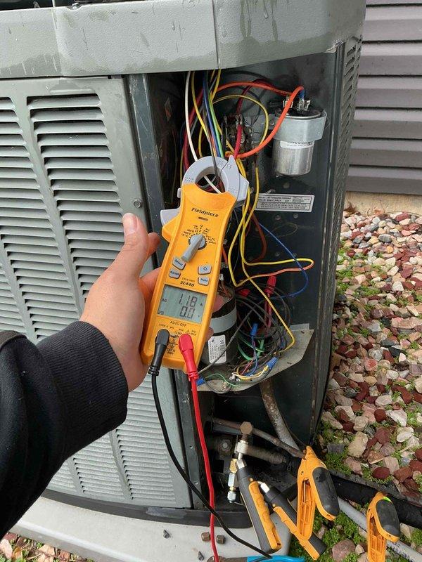 Responded to no cooling call at residential property. Upon inspection, diagnosed failed dual run capacitor as cause of system failure. Tested capacitor with digital multimeter, confirming it was out of specification and preventing compressor and condenser fan motor operation. Removed defective capacitor and installed replacement unit, restoring proper electrical function to outdoor condensing unit. Verified system startup, confirmed compressor and fan motor operation, and tested overall cooling performance. Unit operating within normal parameters upon completion.