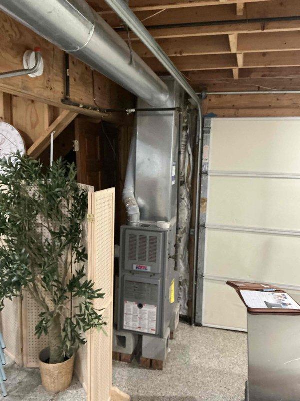 Completed sales estimate for air conditioning system replacement at residential property. Evaluated existing HVAC system located in garage area, including current furnace unit and ductwork configuration. Assessed installation requirements for new AC unit and evaporator coil replacement, examining existing ductwork runs, electrical service accessibility, and optimal equipment placement. Documented current system setup with photos showing furnace cabinet, supply and return duct routing along ceiling joists, and available workspace for new equipment installation. Provided comprehensive estimate for complete AC and coil replacement to address client's cooling system needs.