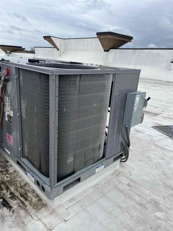 Completed scheduled BFMA preventive maintenance on commercial rooftop unit including comprehensive tune-up and filter replacement. Replaced four pleated air filters in the 2x2 grid configuration within the RTU's filter compartment, ensuring proper airflow and filtration efficiency. Performed standard AC service inspection of the rooftop unit, verifying operational status of condenser coils, refrigerant pressures, electrical components, and disconnect box. All filters were properly secured in mounting framework, unit tested and confirmed operational upon completion.