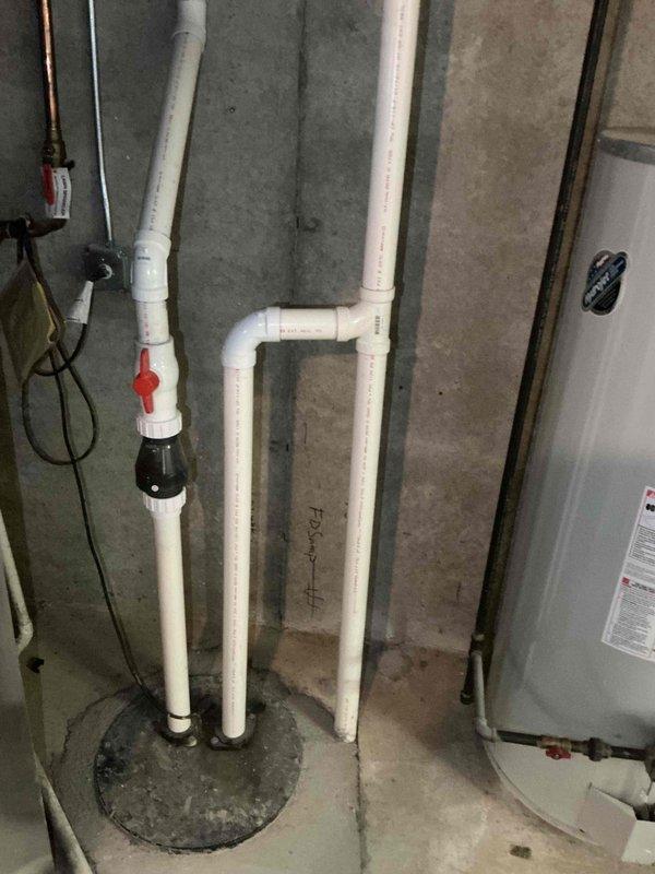 Completed BFMA tune-up on residential HVAC system. Performed electrical diagnostics using digital multimeter, verified voltage readings at 6.77 AC volts to ensure proper system operation. Inspected basement utility area including water heater, PVC plumbing connections, and associated mechanical systems to confirm no interference with HVAC equipment operation.