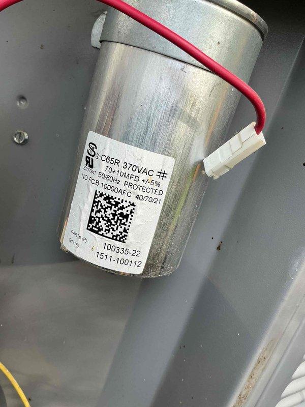 Completed comprehensive AC tune-up maintenance on outdoor condensing unit. Inspected dual-run capacitor (C85R 370VAC, 50/60+10MFD) for proper operation and electrical connections; component showed normal wear consistent with system age. Evaluated condenser coil condition, noting significant debris accumulation and reduced airflow; coil requires cleaning to restore optimal heat transfer efficiency and system performance.