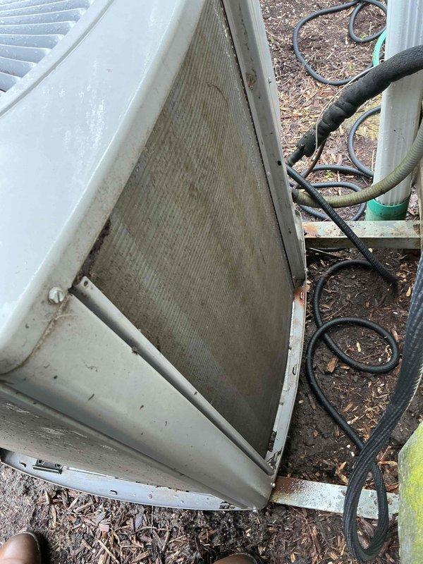 Completed comprehensive AC tune-up maintenance on outdoor condensing unit. Inspected dual-run capacitor (C85R 370VAC, 50/60+10MFD) for proper operation and electrical connections; component showed normal wear consistent with system age. Evaluated condenser coil condition, noting significant debris accumulation and reduced airflow; coil requires cleaning to restore optimal heat transfer efficiency and system performance.