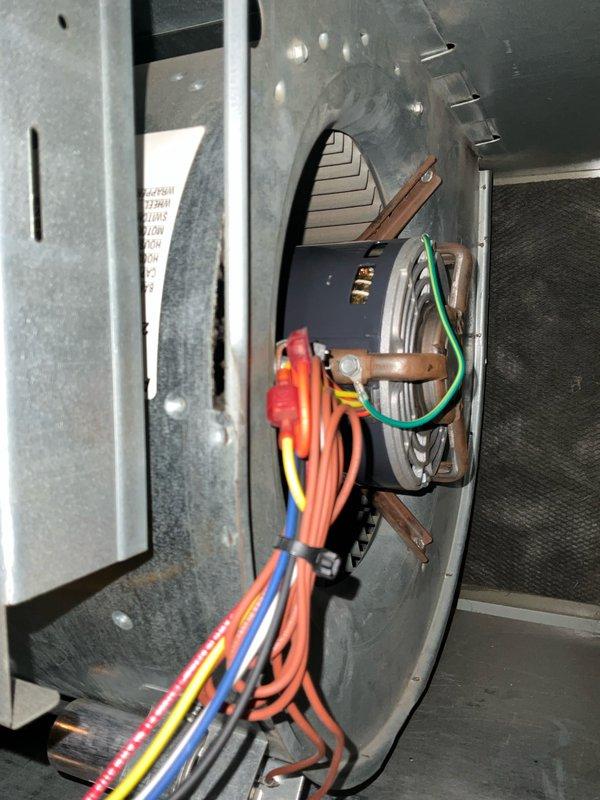 Completed comprehensive air conditioning tune-up on 12+ year old system, including inspection of all electrical components, control panel, Emerson SureSwitch relay module, and Titan motor run capacitor rated at 70 MFD 440/370V. Inspected blower motor assembly, verified all wire connections and terminals, checked ground connections, and documented system condition with photos of control panel and motor wiring assembly.